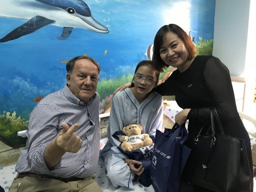  Pictures of Mr. Rad Kivette and Ms. Tran Thi Hanh, Head of HR - PEB Steel Buildings, giving gifts to children